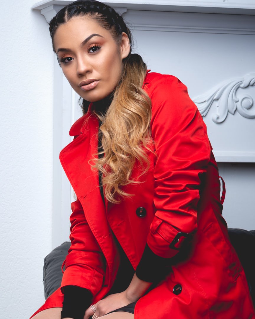 Artistic Emages Dallas branding portrait — confident woman in red trench coat showing warmth and power