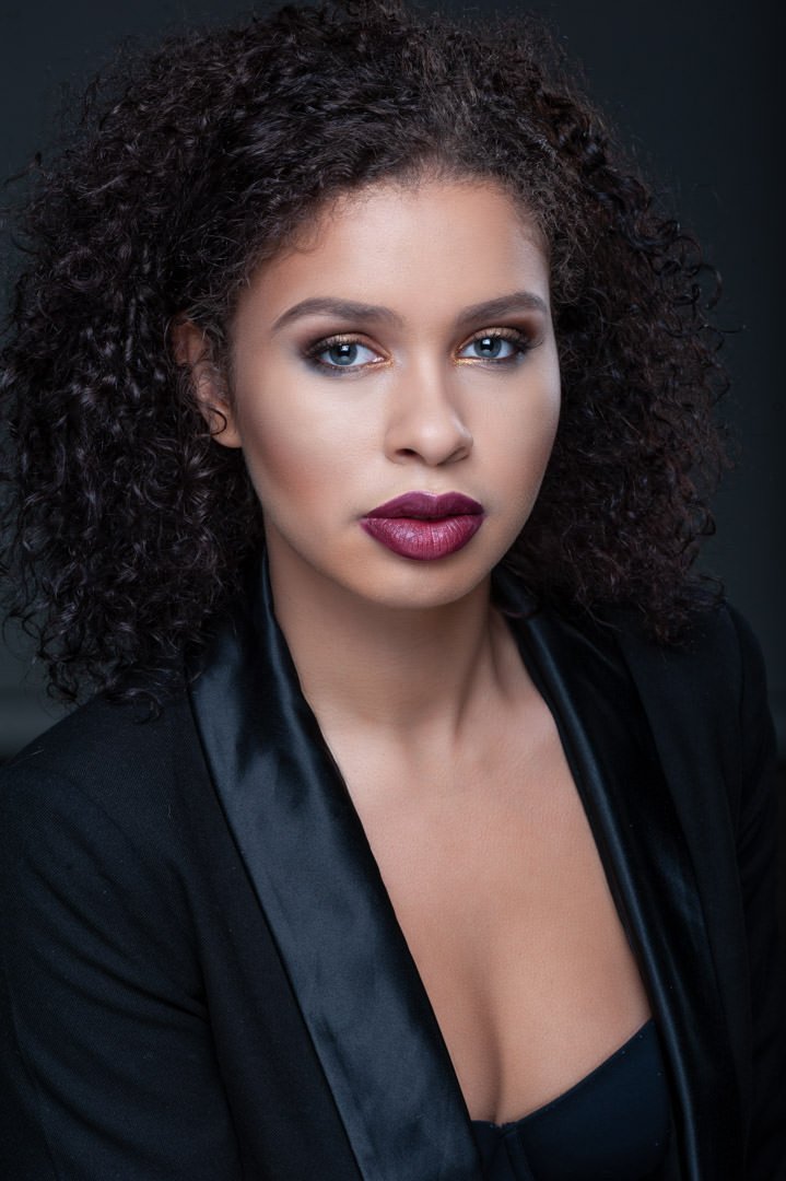 (c)Artistic Emages Photography apply for luxury branding photography in Dallas – confident woman in black suit with authority and presence