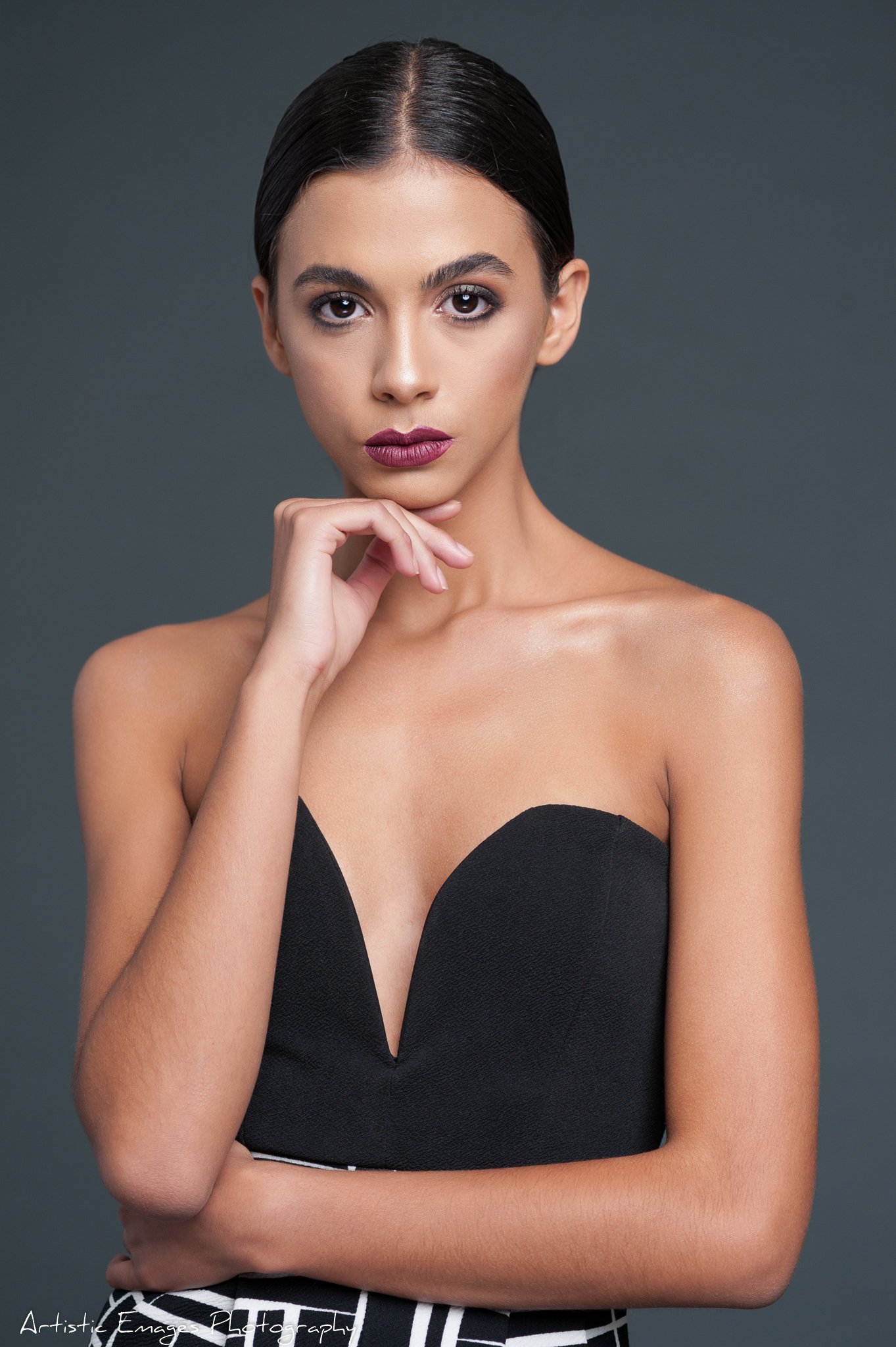 (c)Artistic Emages Photography High end branding photographer Dallas portrait of an elegant woman in a strapless black dress, styled for luxury and authority.